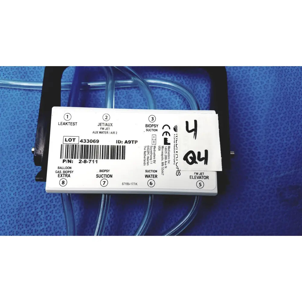 White rectangular medivators hook-up block unit with labeled ports is a compatible component for medical suction and biopsy