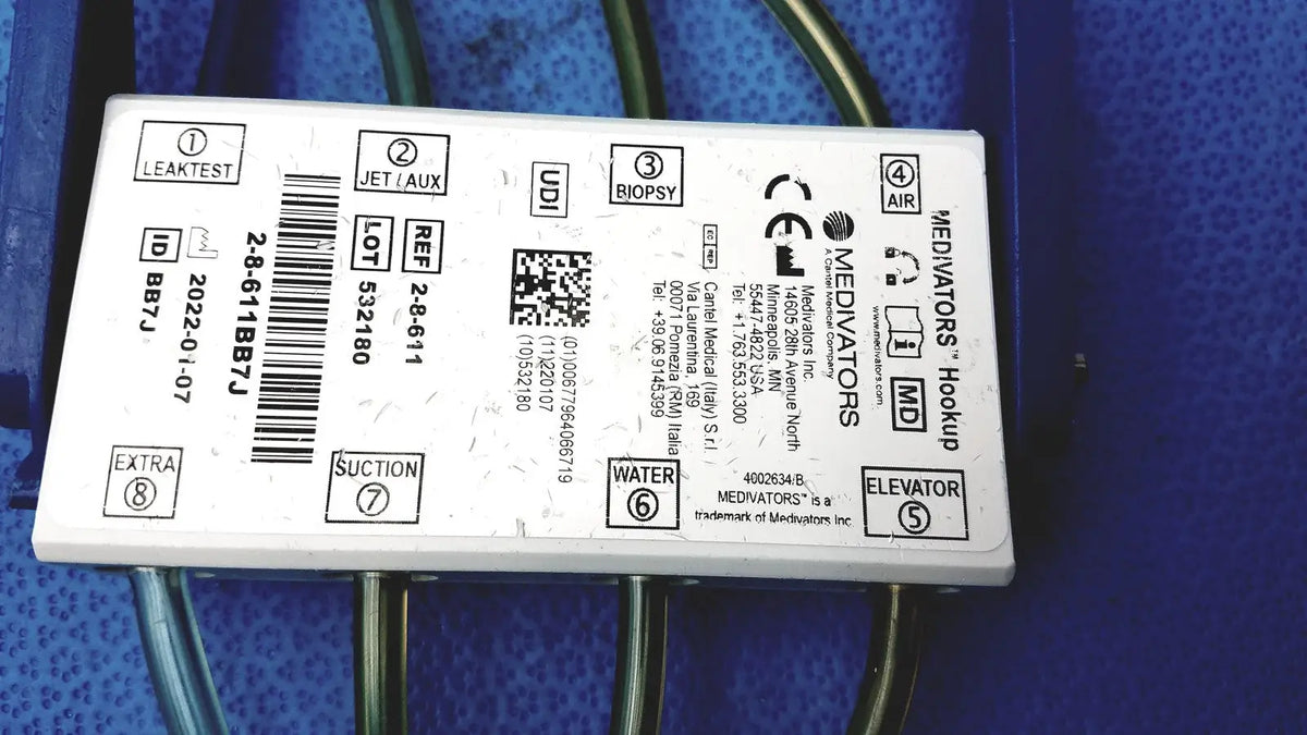 White rectangular medivators hook-up connector assembly 950627 with black printed labels and symbols for medical use