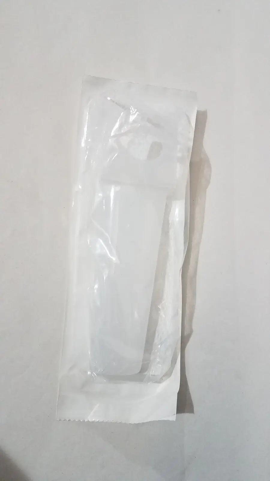 A white plastic-wrapped disposable medical syringe shown with the medline electrosurgical safety holster esh1 secure surgical tool holder