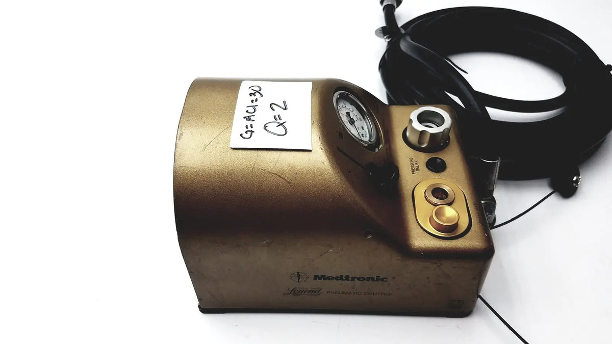 Gold-colored metallic medtronic midas rex legend gold pneumatic drill foot control unit with pressure gauge and control knobs