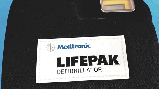 Black medtronic lifepak 1000 defibrillator with white label showing brand and model suitable for reuse medical with quik-pak pads