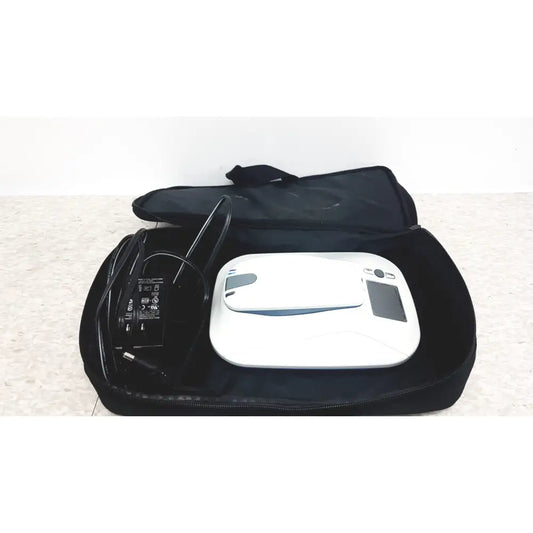White robotic vacuum cleaner with black accents shown alongside medtronic mycarelink remote patient monitor model 24955