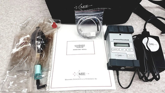Black and gray mie personal dataram environmental monitor with digital display and labeled buttons for real-time aerosol tracking