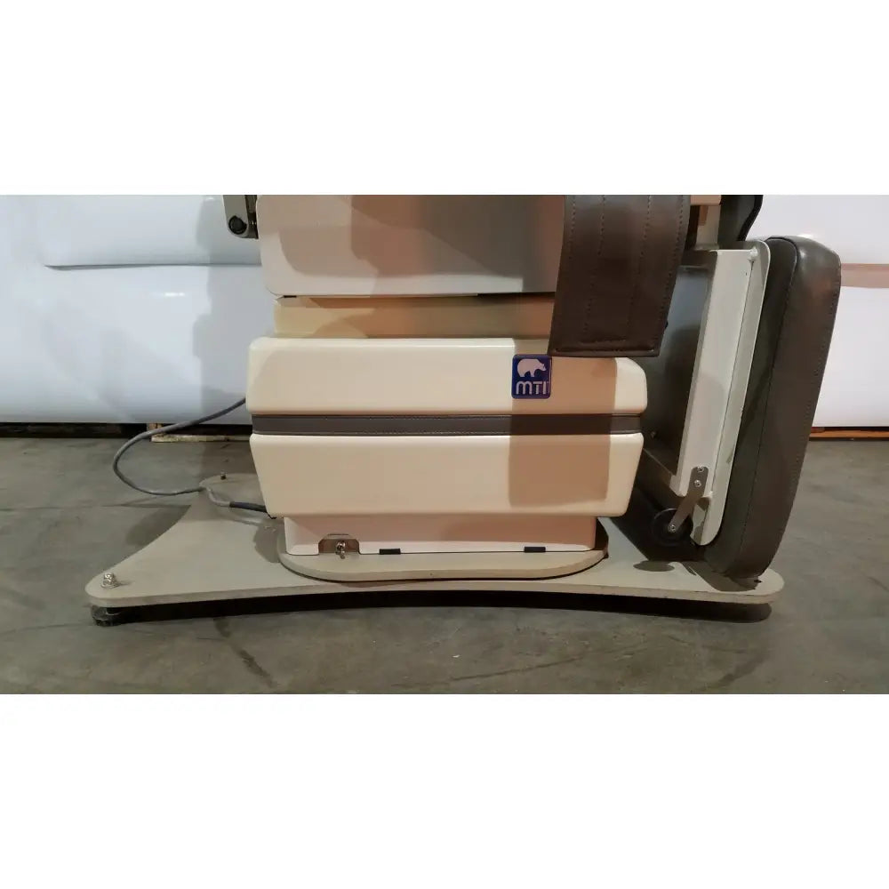 Beige and brown mti programmable podiatry chair with foot control featuring sleek modern design and premium materials