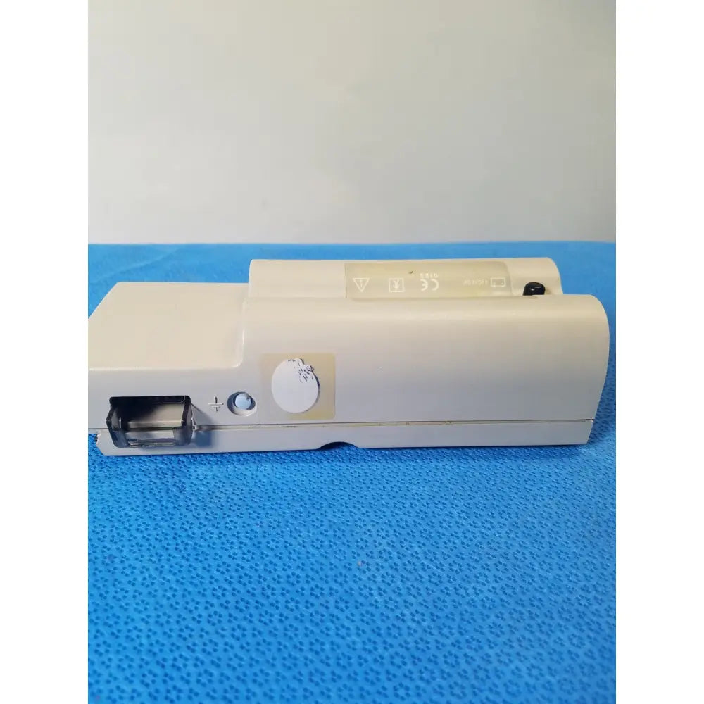 Beige nellcor puritan bennett portable pulse oximeter with circular dial and rectangular port on the side in case