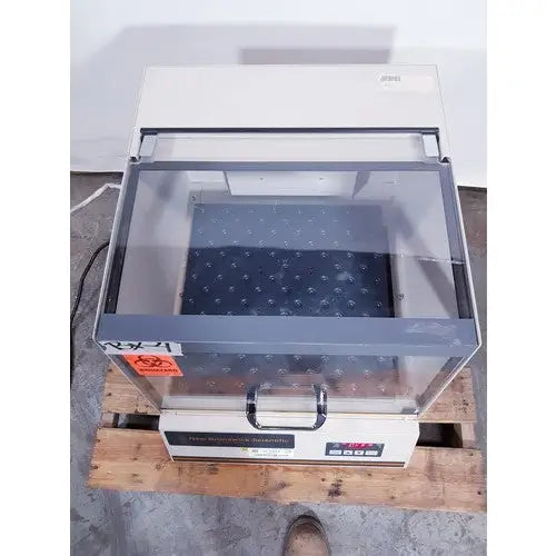 Beige and gray laboratory-grade biosafety cabinet with glass front and digital control panel by brunswick scientific classic c24
