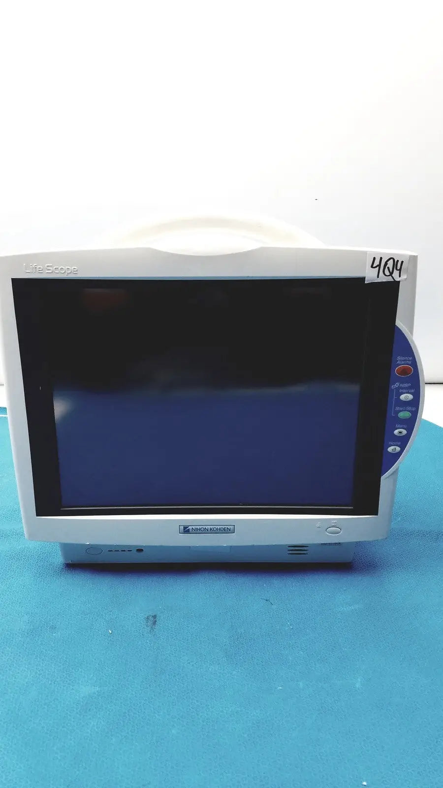 White Nihon Kohden BSM-6701A life scope bedside patient monitor with dark screen and blue control panel on the right side