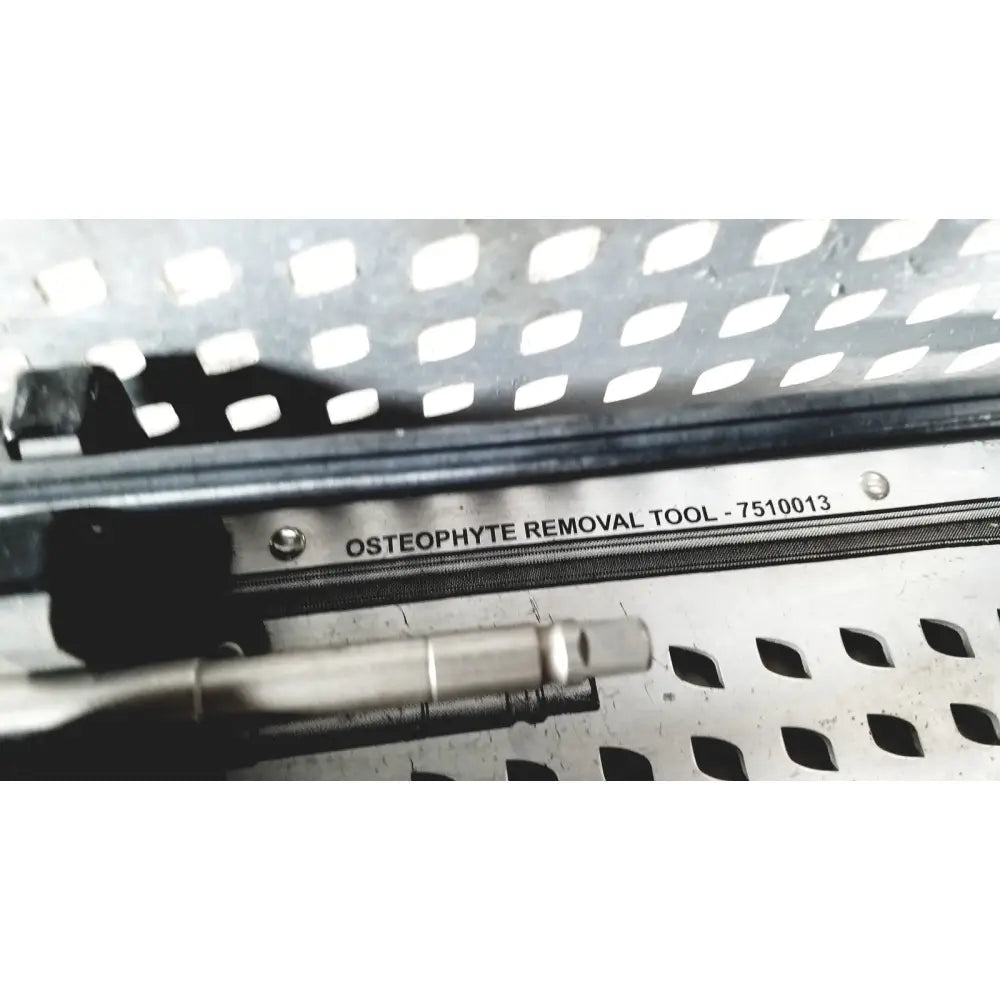 Stainless steel osteophyte removal tool with metallic finish and engraved label in nuvasive speed innovation coroent xl-fixation tray