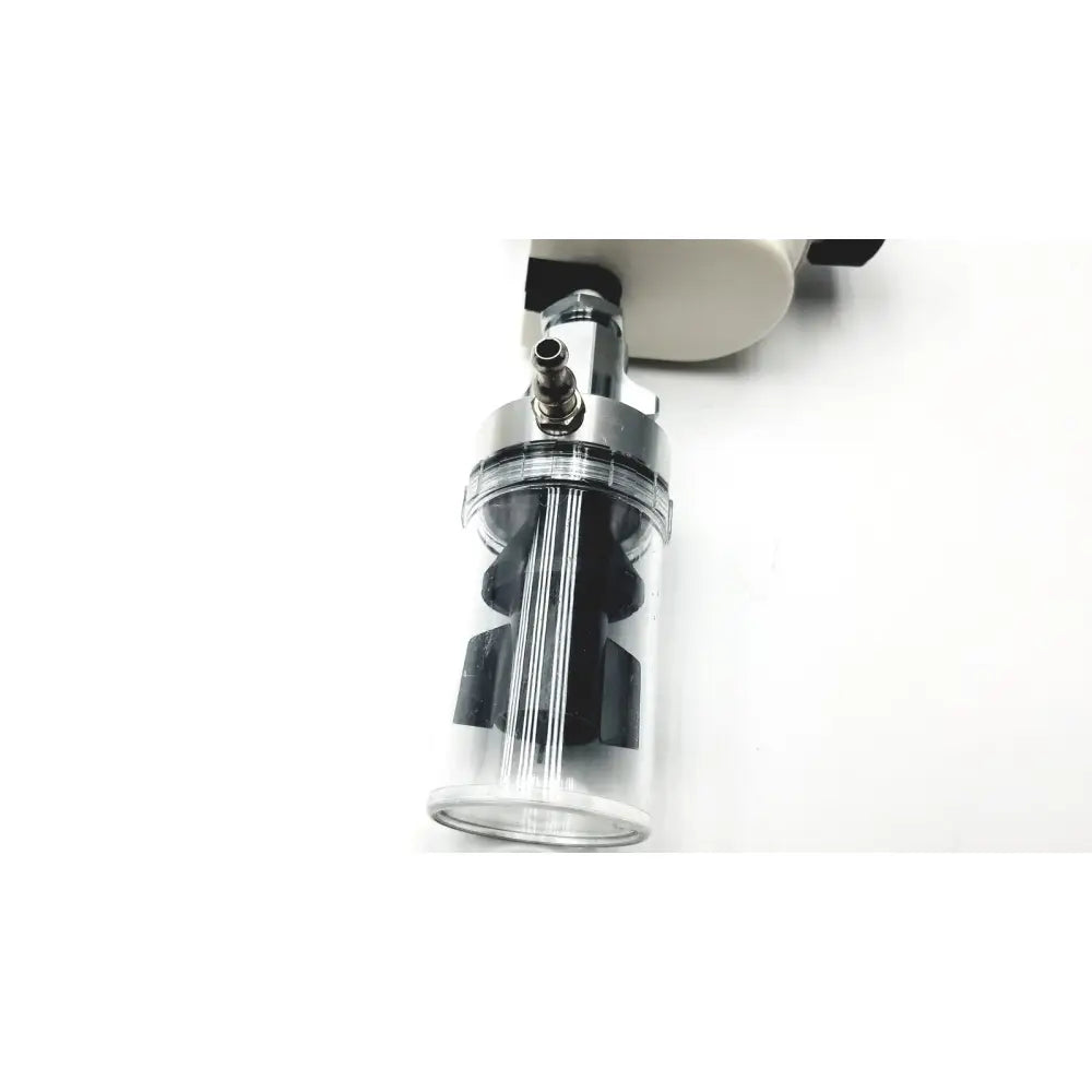 Clear cylindrical ohio vacuum regulator with black internal parts and metallic top attached to white device model pisa