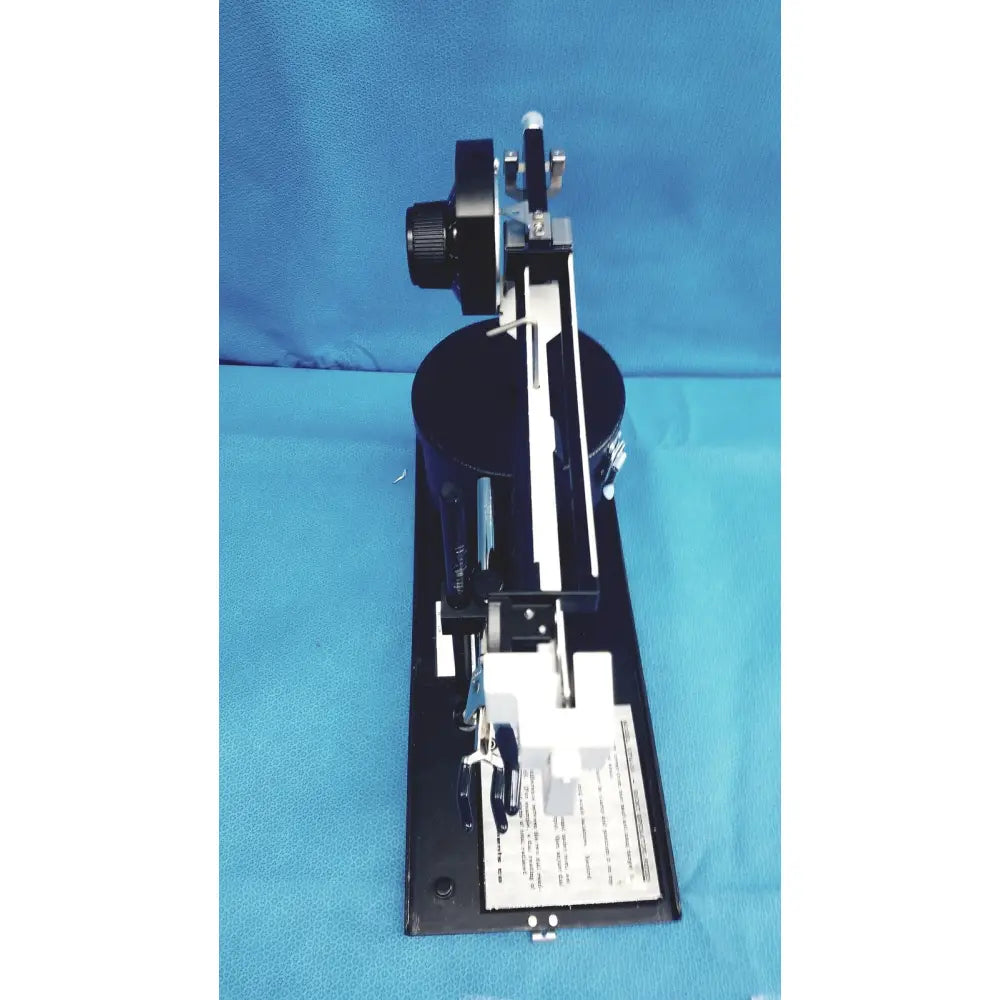 Black metal optical bench with adjustable components and mounted lens assembly for ohmic instruments ultrasound power meter scale