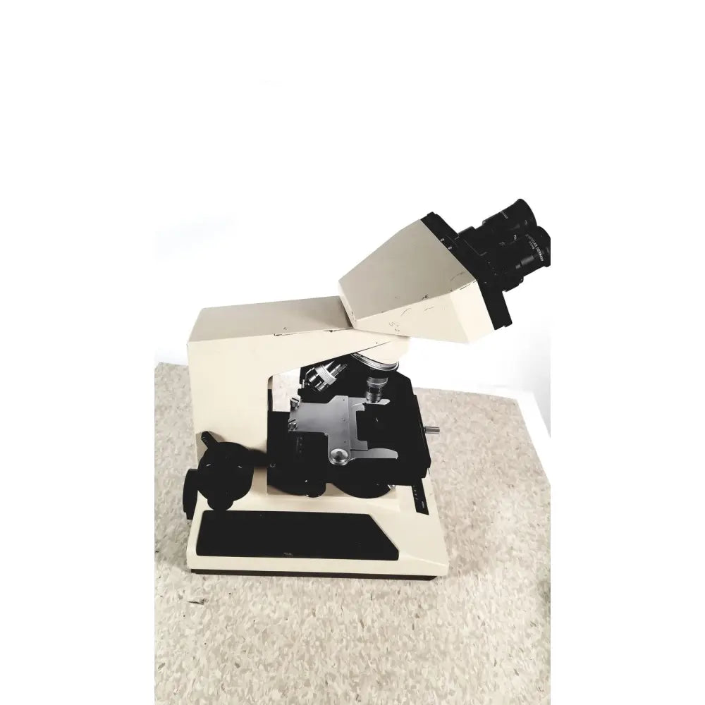 Beige and black olympus bh-2 binocular microscope with dual eyepieces and adjustable stage for precise lab work