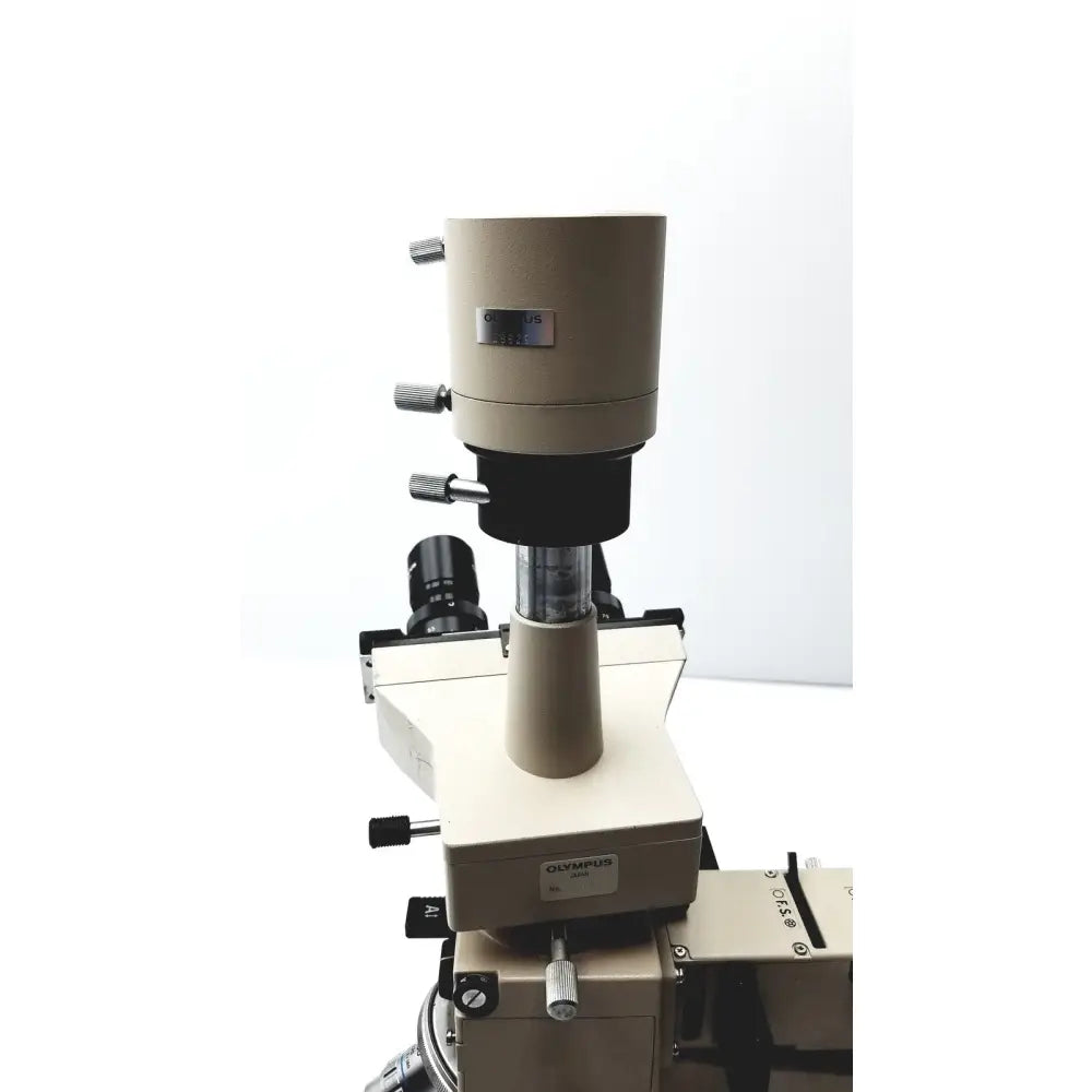 Beige Olympus Optical BH2-UMA microscope with black optics and metallic adjustment knobs for precise laboratory use