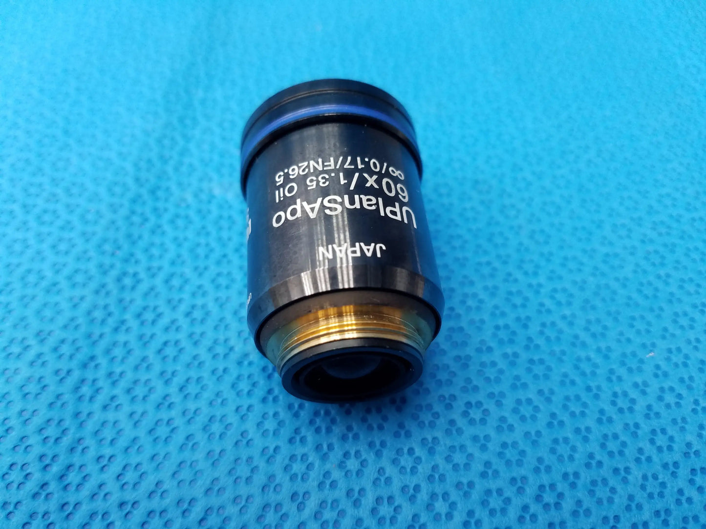 Olympus UPlanSApo 60x oil immersion microscope objective lens with gold threaded mount featuring high numerical aperture and field number