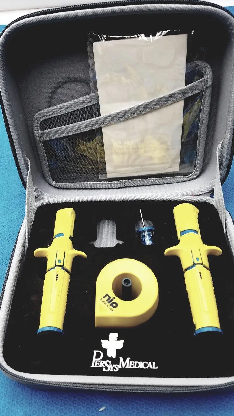 Yellow persys medical nio adult simulation kit inhaler devices with blue accents in black and gray carrying case