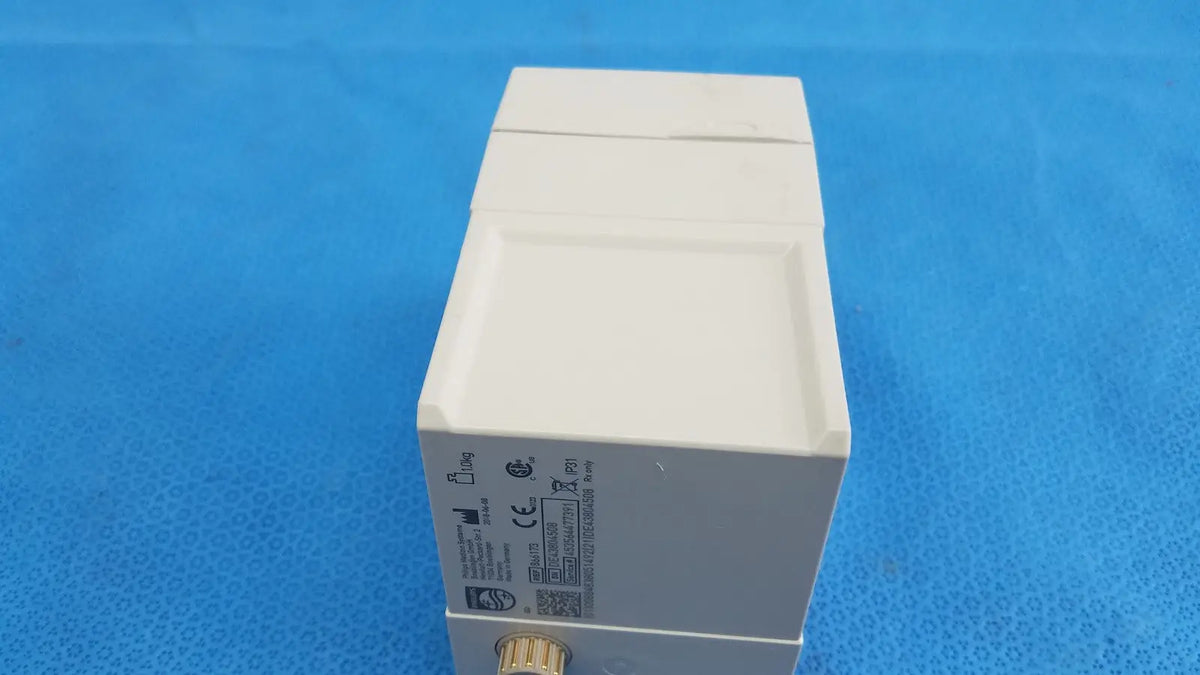 White rectangular philips intellivue g7m module with metallic gold connector and certification labels on its side