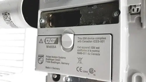 Silver metallic label with black compliance certifications on the back of philips intellivue mp30 de52614137 device with stand