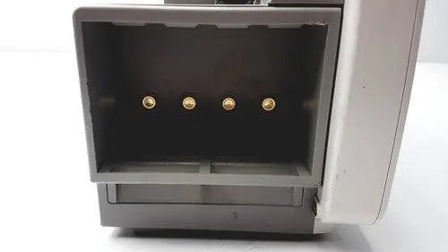 Gray plastic philips intellivue patient monitor with four gold circular connectors visible inside open back compartment