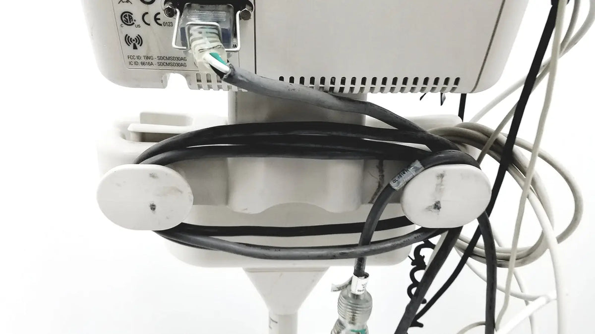 White philips suresigns vs4 vital medical device with black coiled cables and green ethernet port visible on back side