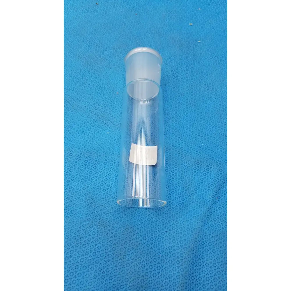 Clear plastic pyrex ground glass cylindrical container with frosted white cap and rectangular label for lab use