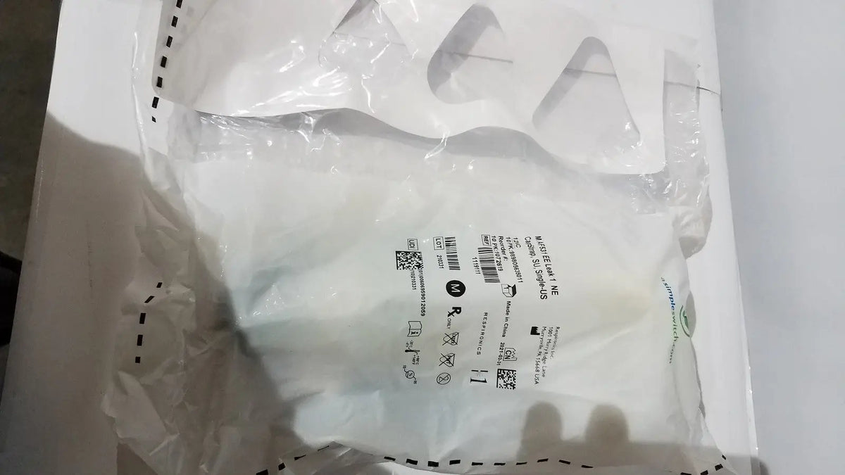 White plastic bag of respironics af531 ee leak genuine oem capstrap single-use with care labels and barcode sealed at top