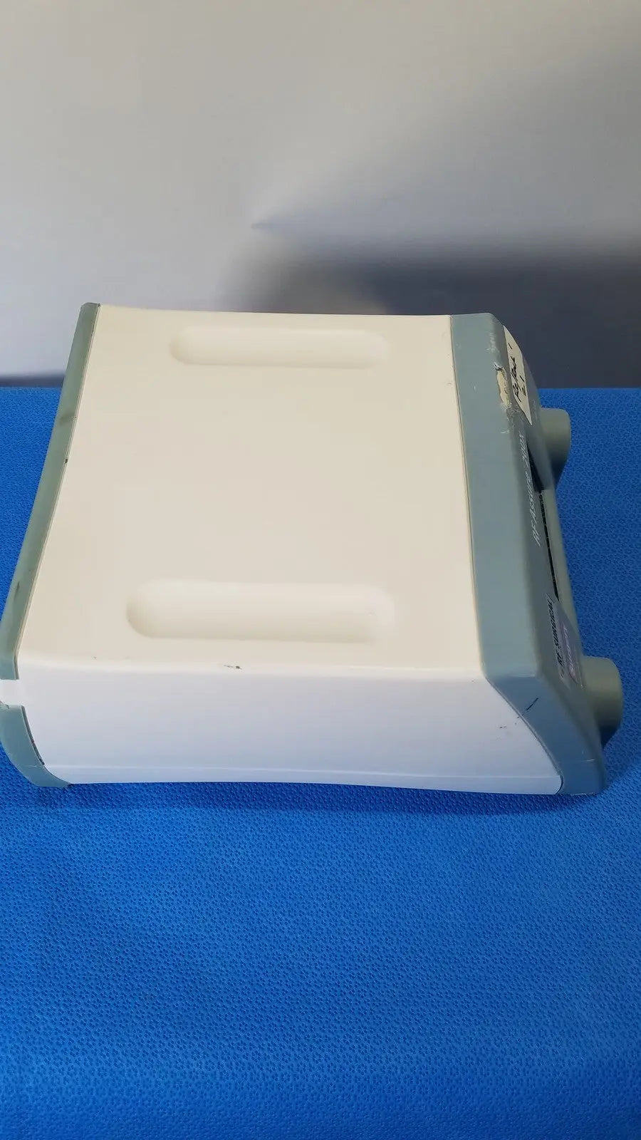 White and gray RF Assure Detection Console model 200X with rectangular body and recessed top handles for easy transport