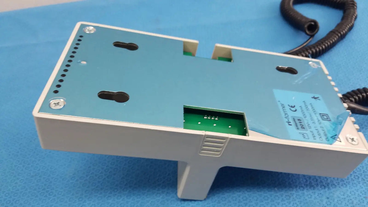 Light blue and white plastic ri-former diagnostic station extension module with one handle and coiled black cable attached