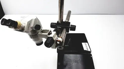 Silver and black ssz stereo zoom binocular microscope with adjustable focus knobs on a sturdy metal stand