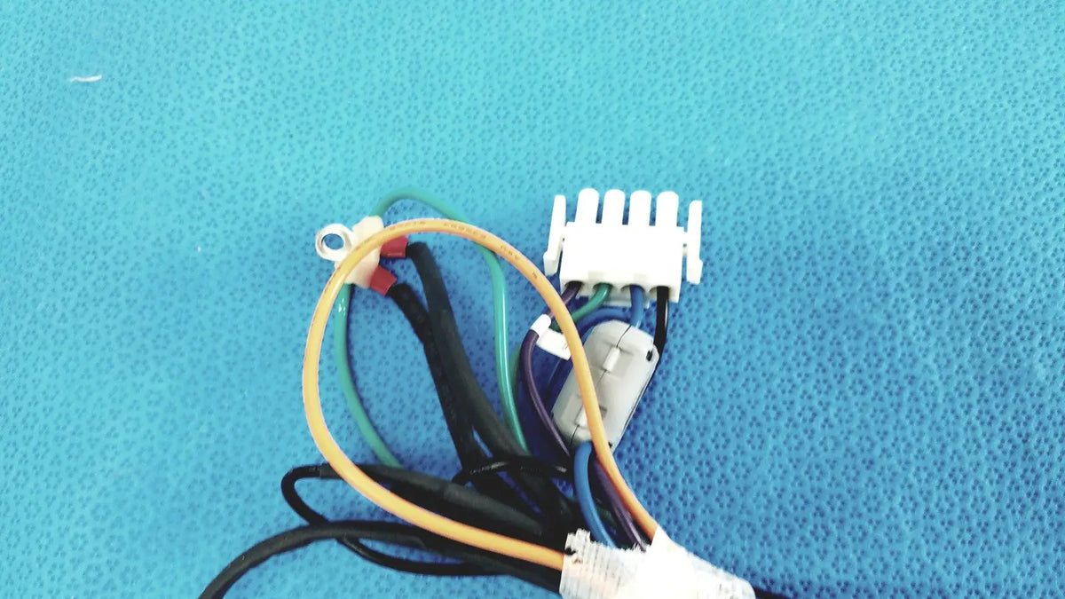A white plastic multi-pin connector with yellow green blue and black wires for seiwa ferrite connectors lead wire harness cable