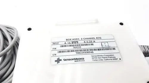 White plastic SensorMedics 3-channel ECG box with two-channel ECG label and coiled gray cable for monitoring