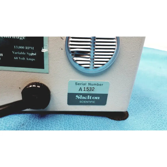 White shelton scientific vsmc-13 benchtop laboratory centrifuge with blue-rimmed vent and black control knob compact design