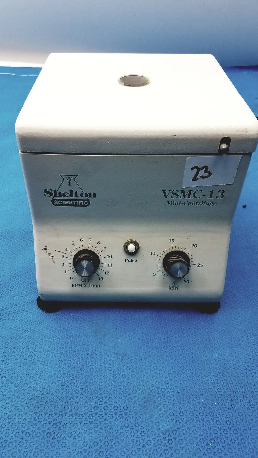 White plastic shelton scientific vsmc-13 benchtop laboratory centrifuge with two rotary dials and central pulse button