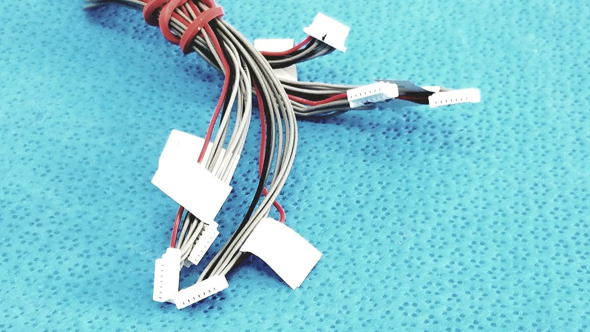 A bundle of multi-colored flat cables with white plastic connectors in shinagawa awm 1007 female connectors wire harness
