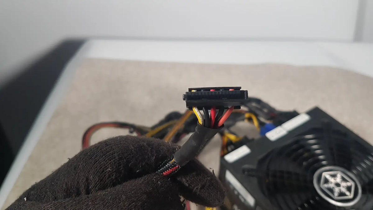 Black plastic 6-pin pcie power connector with color-coded wires of silverstone 1200w strider gold power supply