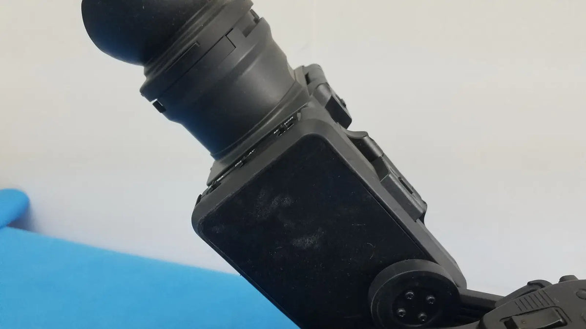 Black plastic camera lens mount with matte finish and screw holes on sony pmw-300 memory xdcam camcorder back side