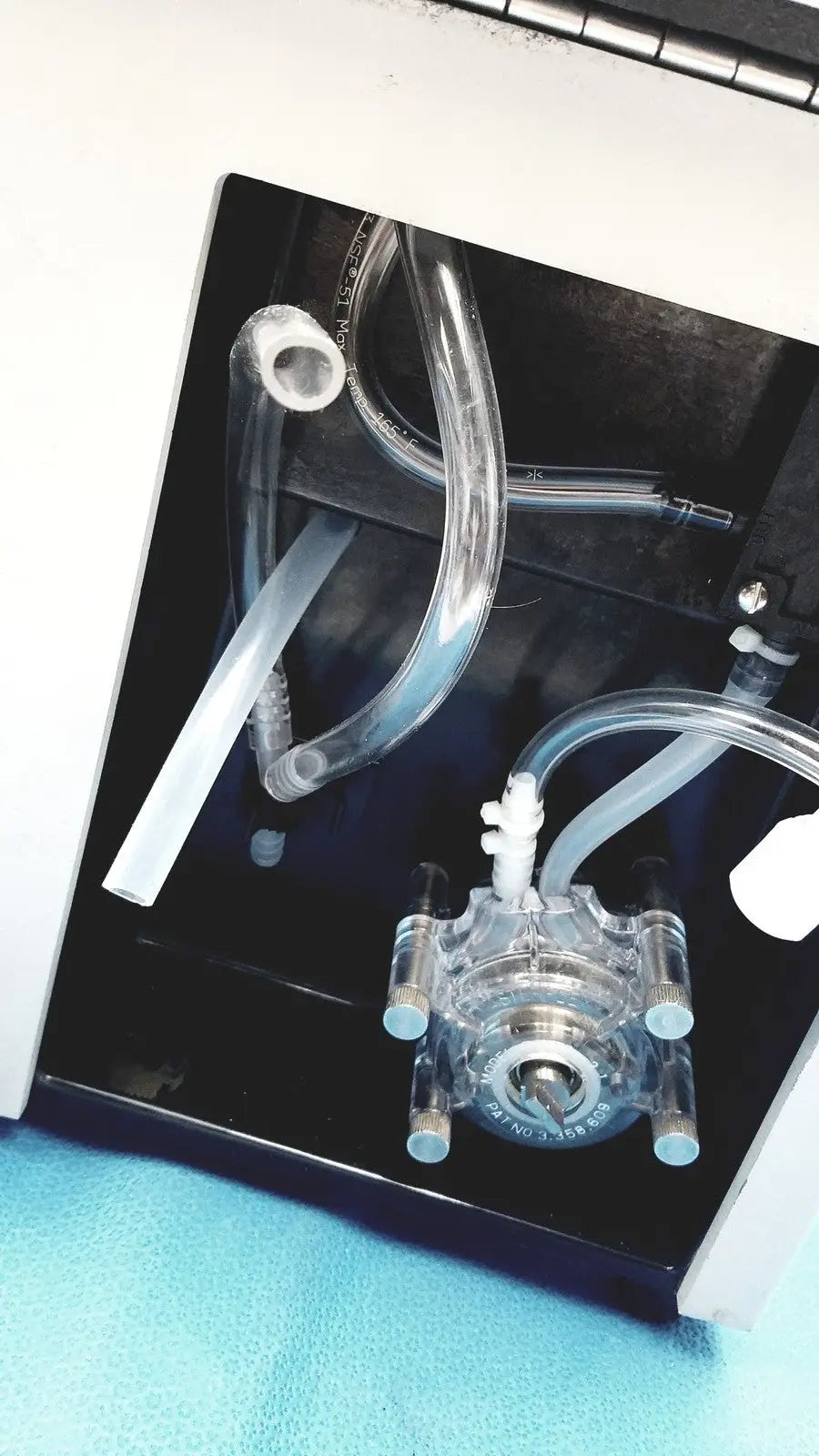 Clear plastic fluid pump with transparent tubing and metallic fittings on sorvall instruments cell washer 2 8603815
