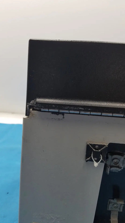 Black metal hinge with wear and silver latch on gray plastic housing of sorvall instruments cell washer 2 8701716