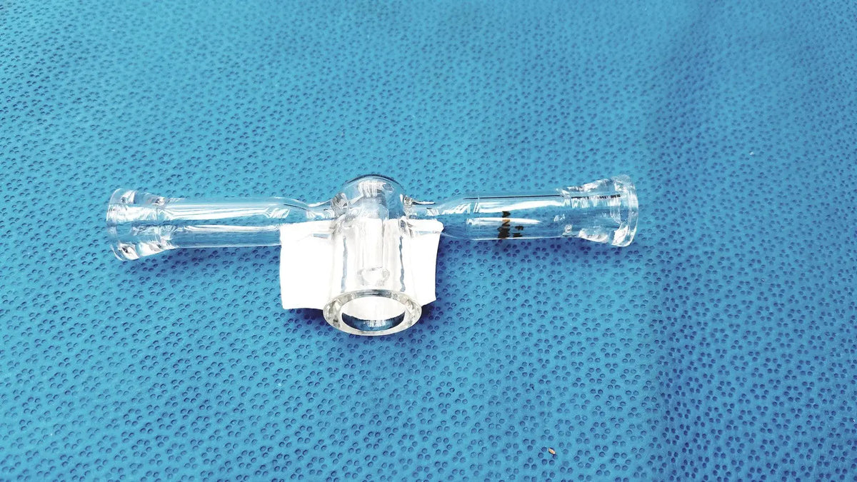 Clear glass spherical joint glass stopcock valve made of borosilicate with central connector and side ports for lab vacuum