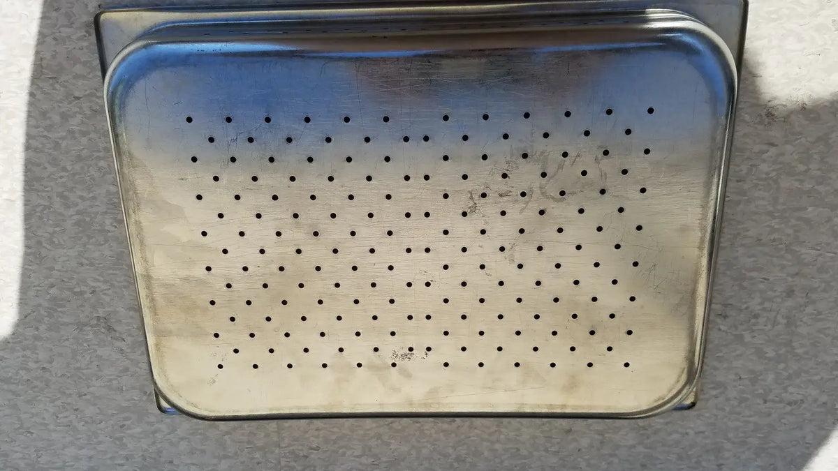 Stainless steel tray rectangular with rounded corners featuring perforated holes in durable steel material