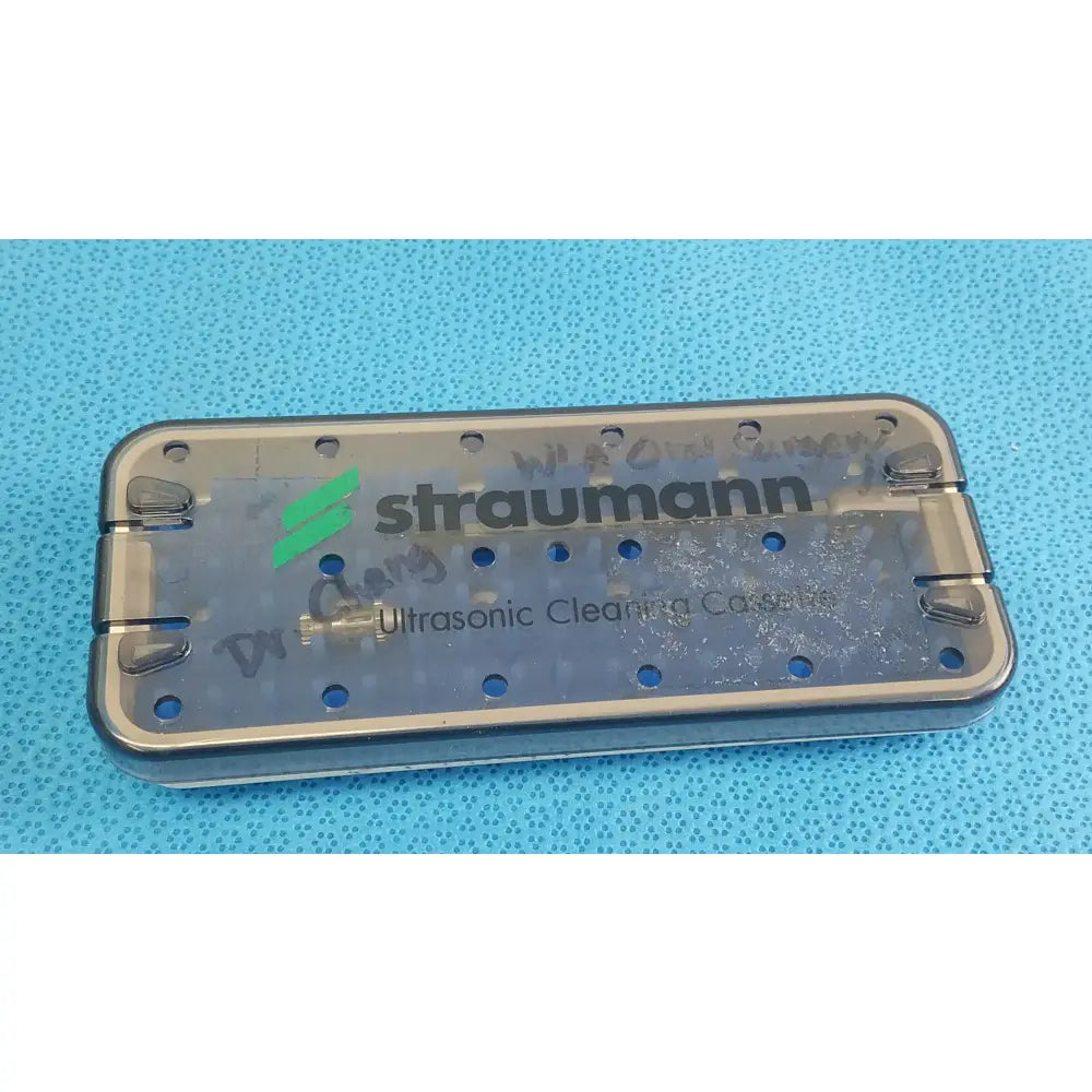 Transparent straumann ultrasonic cleaning cassette with metal frame and circular holes for reuse medical equipment cleaning