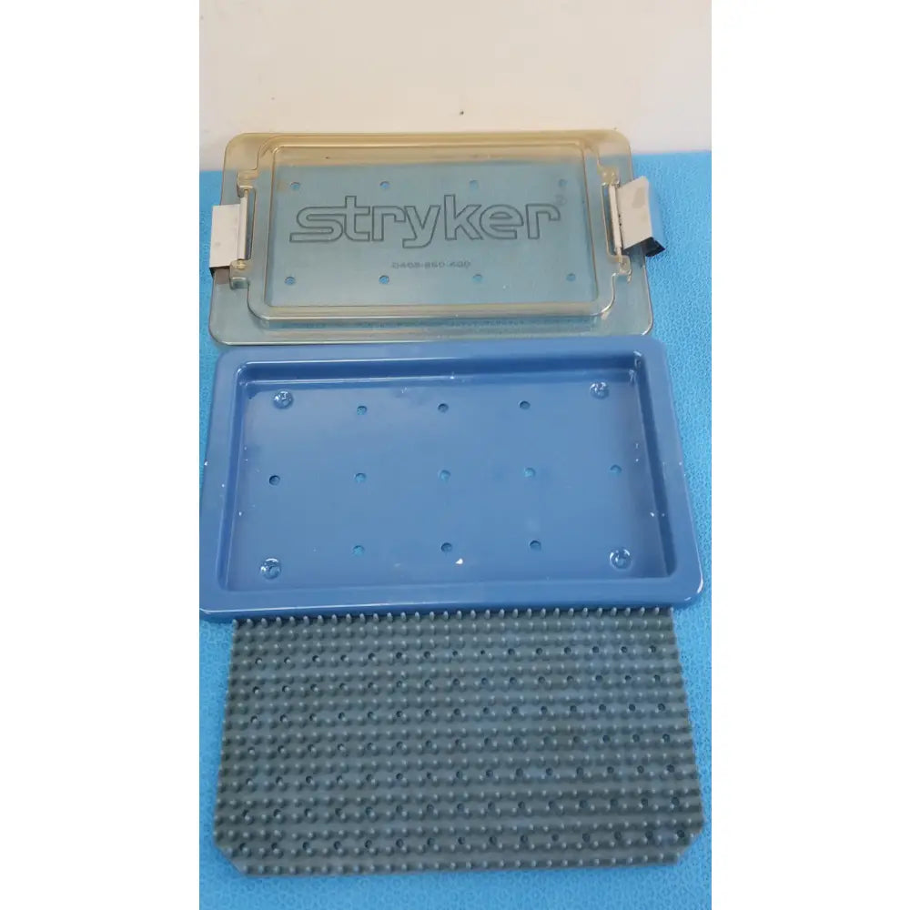 Stryker lightweight sterilization box medical equipment with blue plastic base and textured gray rubber insert for reuse medical equipment