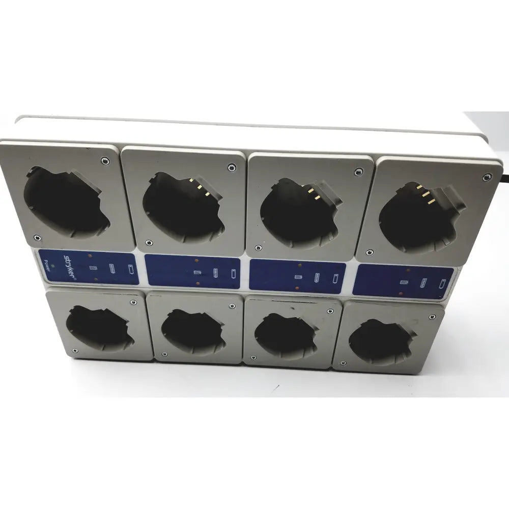 Silver rectangular stryker 400-655 steri-shield t4 eight station battery charger with blue control panels and black compartments