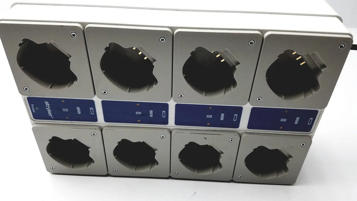 Silver rectangular stryker 400-655 steri-shield t4 eight station battery charger with blue control panels and black compartments