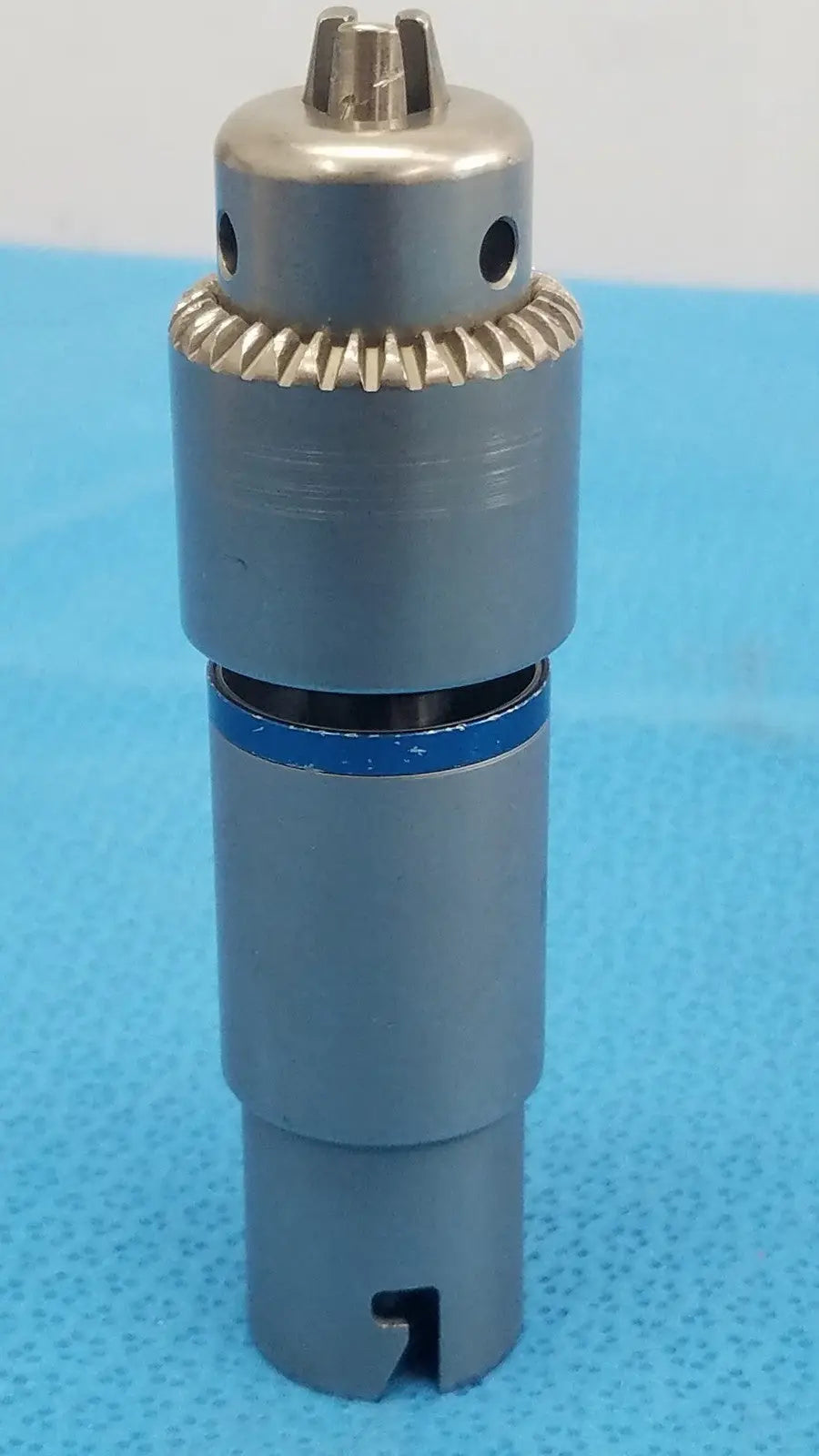 Stryker 4100-131-000 gray metallic 1/4 inch drill attachment with gear-like collar and blue ring for reuse medical use