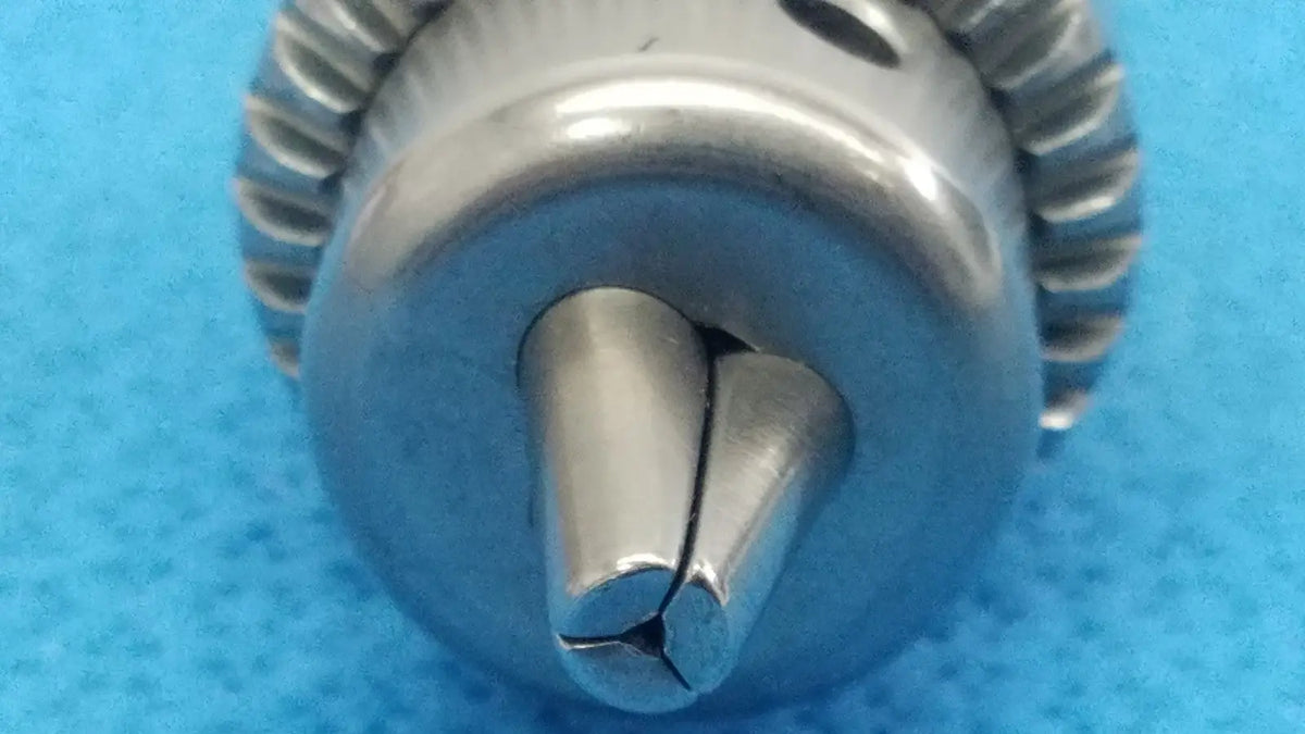 Silver-colored metal drill bit with split-tipped design and gear-like edge for reuse medical stryker 6203-131-000 keyless chuck