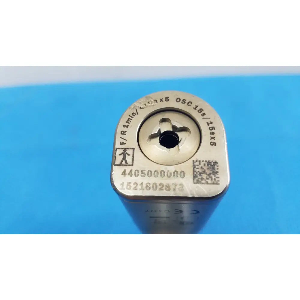 Silver-colored metal tool bit with engraved markings and qr code on top surface for stryker cd4 cordless driver universal handpiece