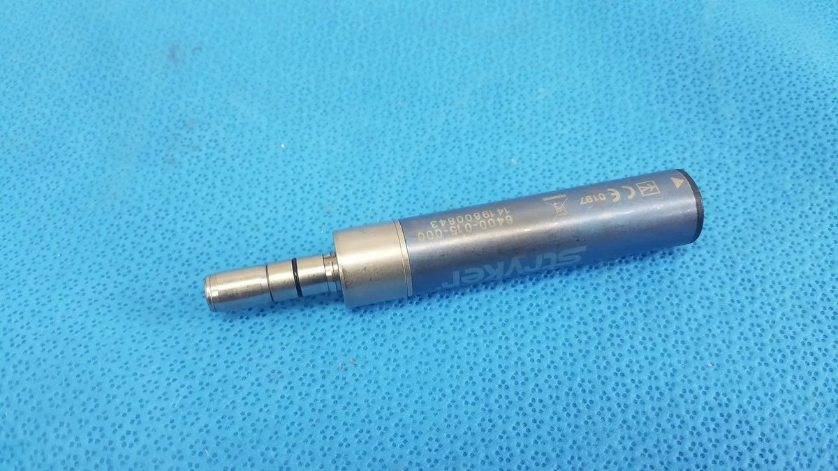 Silver-colored metallic stryker remb electric micro drill handpiece with engraved markings and cylindrical body