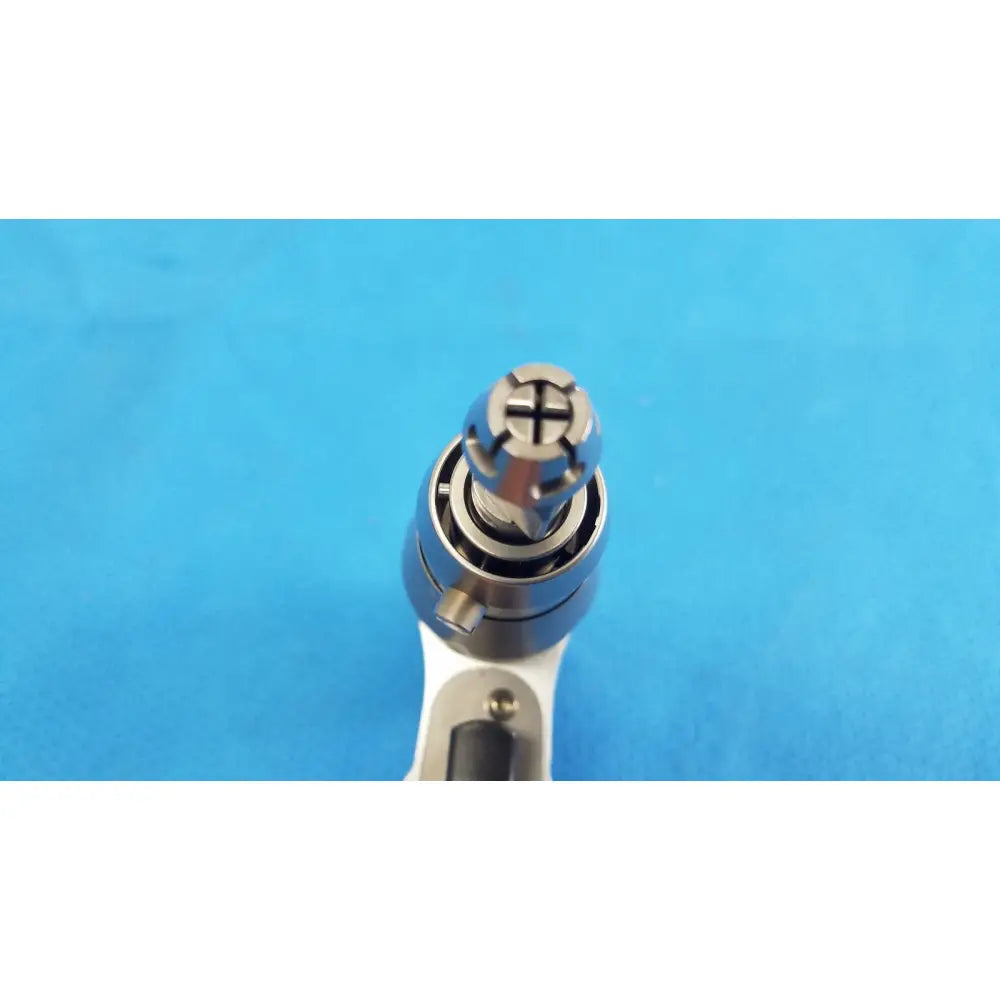 Silver-colored Stryker System 8 sternum saw drill bit with cross-shaped drive tip for reuse medical orthopedic instruments