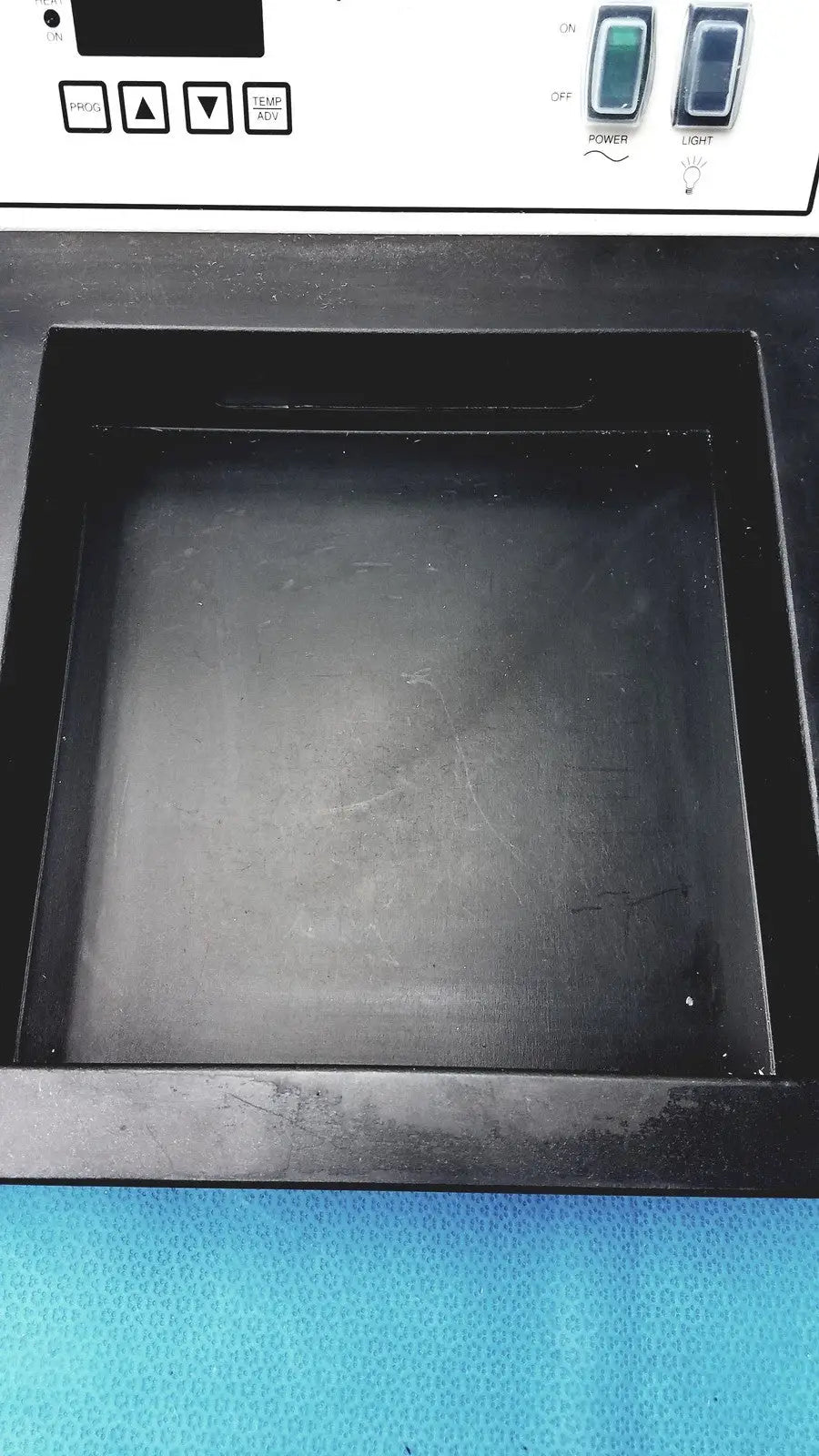 Black rectangular surgipath digital tissue flotation bath with smooth matte finish and raised edges for laboratory use