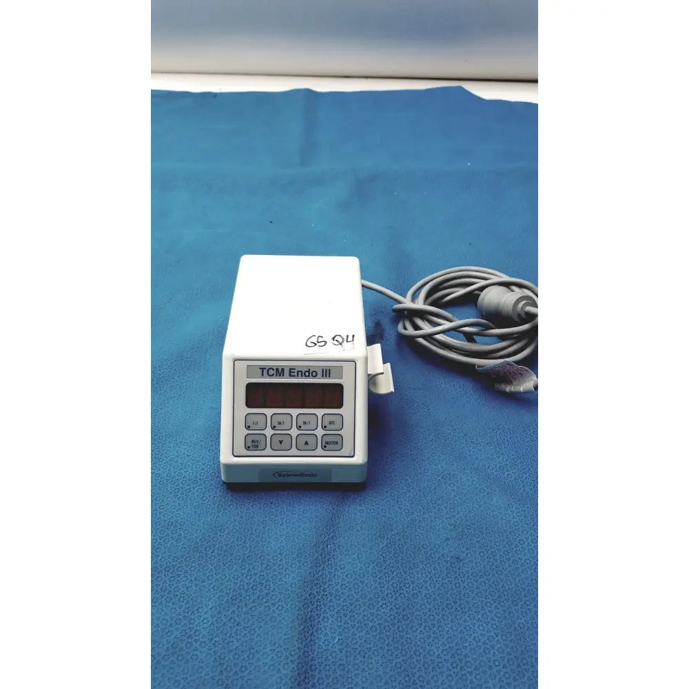 White plastic sybronendo tcm endo iii medical device with digital display and control buttons for endodontic use
