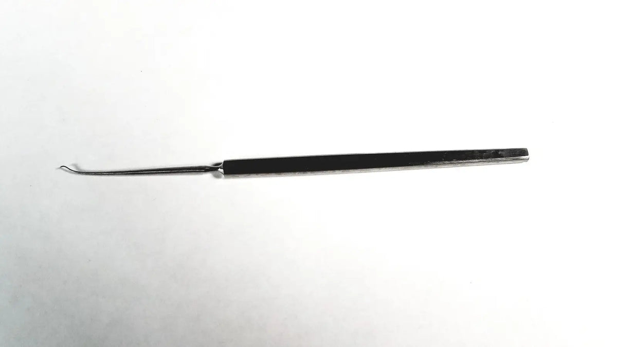 A sleek black-handled symmetry 38-1028 dermal skin sharp surgical instrument with sharp stainless steel shaft